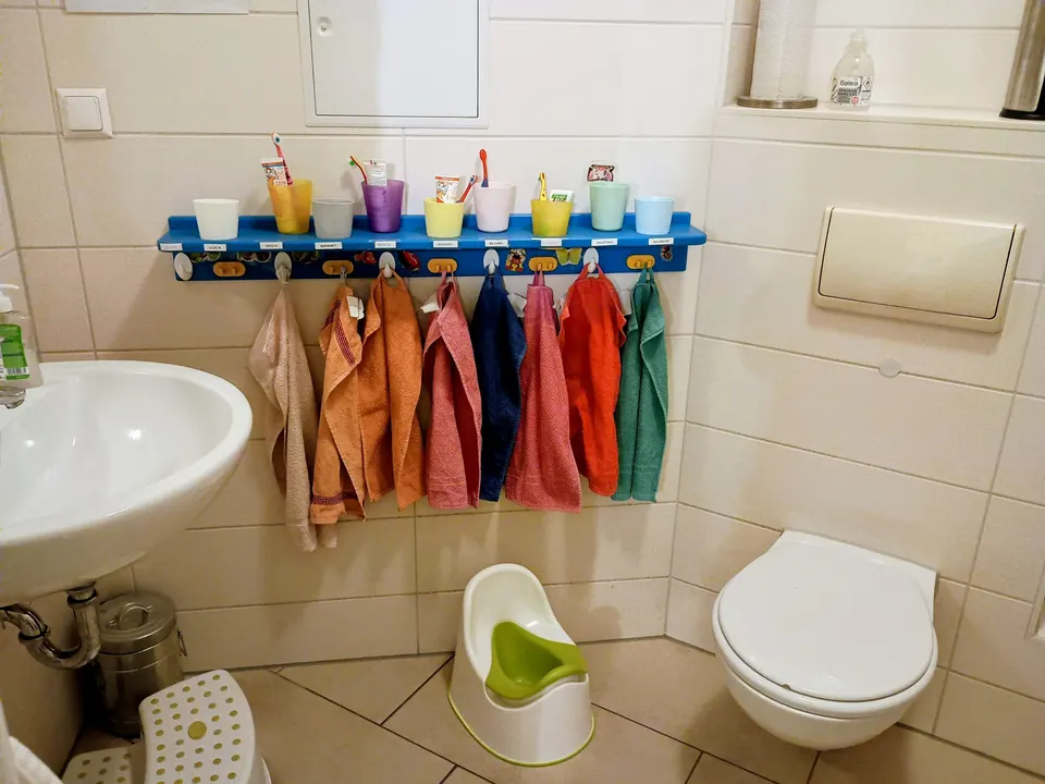 Kindgerechtes Bad mit Waschbecken und bunten Zahnputzbechern